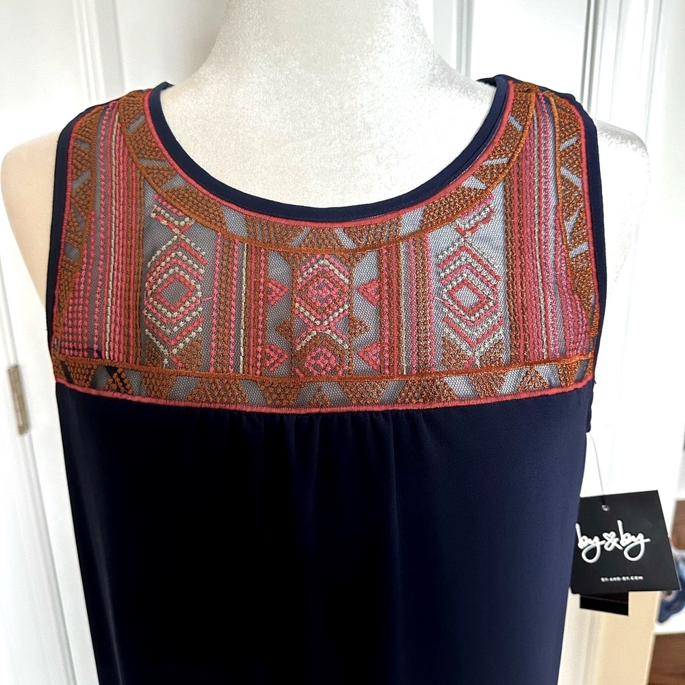 Navy dress with embroidered neckline and keyhole back.